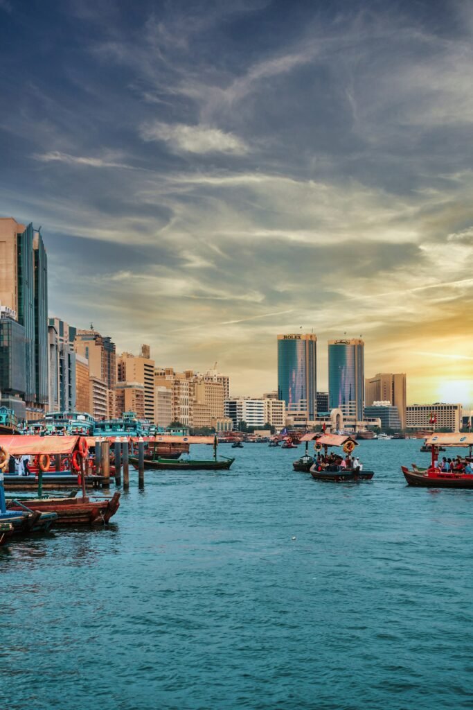 Traditional abra boats crossing Dubai Creek with the Deira skyline behind
