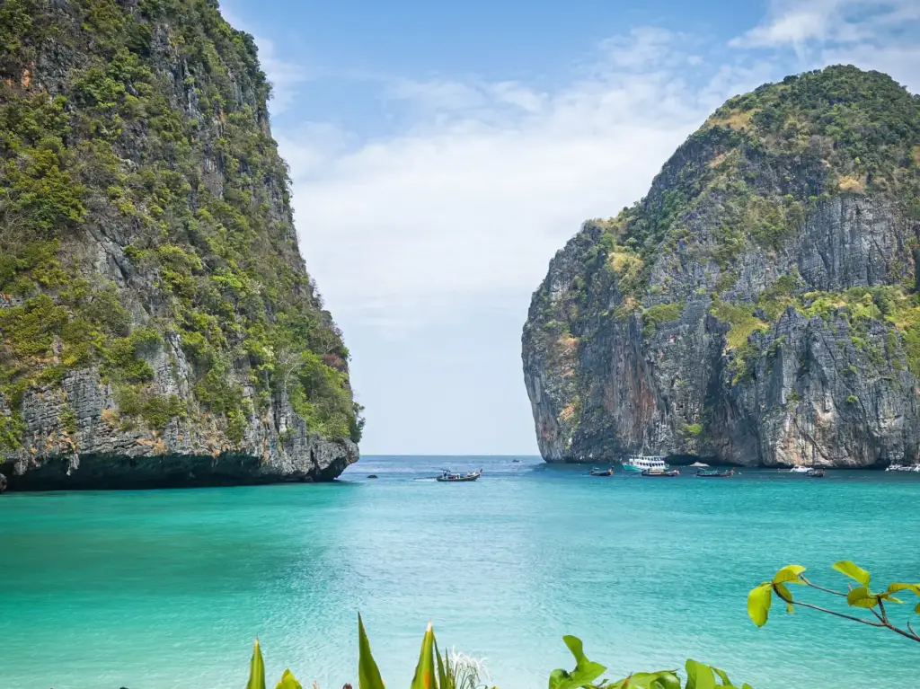 Limestone cliffs enclosing the turquoise water of Maya Bay, Thailand