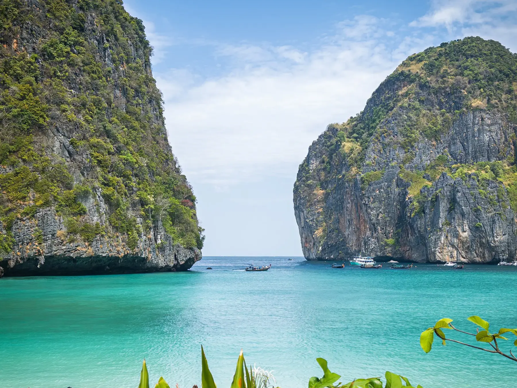 Limestone cliffs enclosing the turquoise water of Maya Bay, Thailand